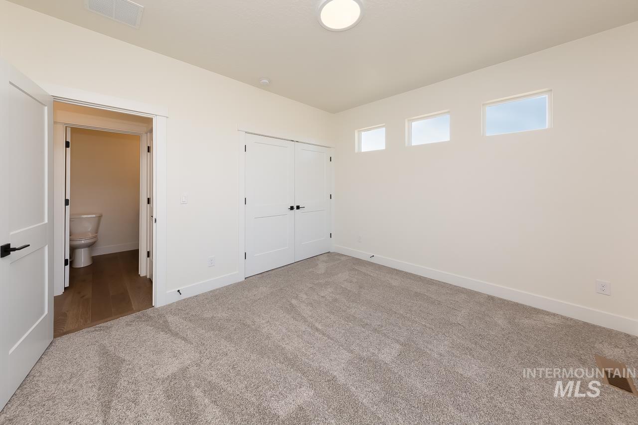 Unfurnished bedroom featuring carpet and a closet