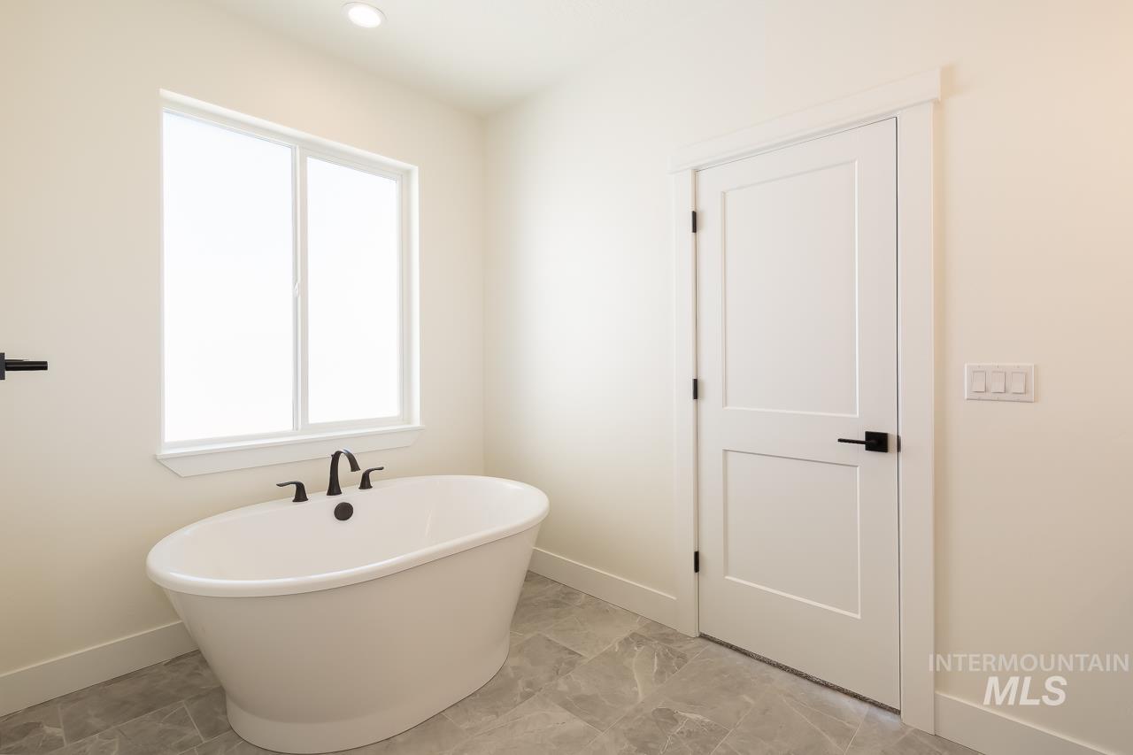Full bathroom featuring a freestanding tub and recessed lighting