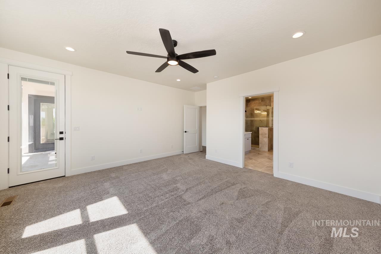 Unfurnished bedroom featuring light colored carpet, ensuite bathroom, a ceiling fan, and recessed lighting