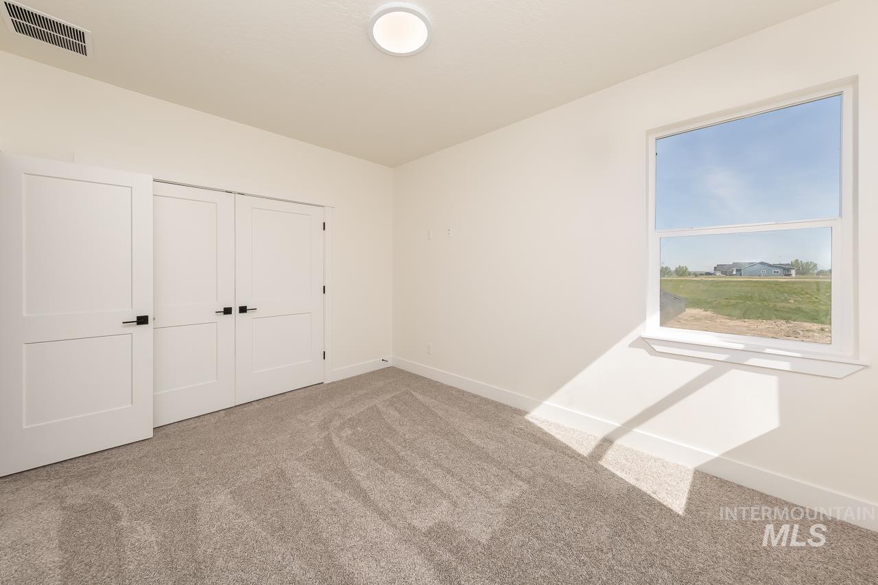 Unfurnished bedroom with carpet and a closet