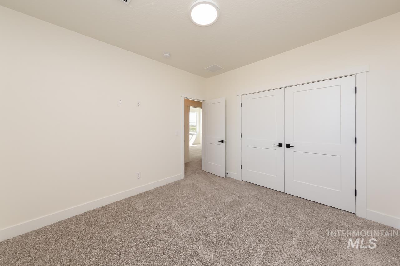Unfurnished bedroom with carpet flooring and a closet