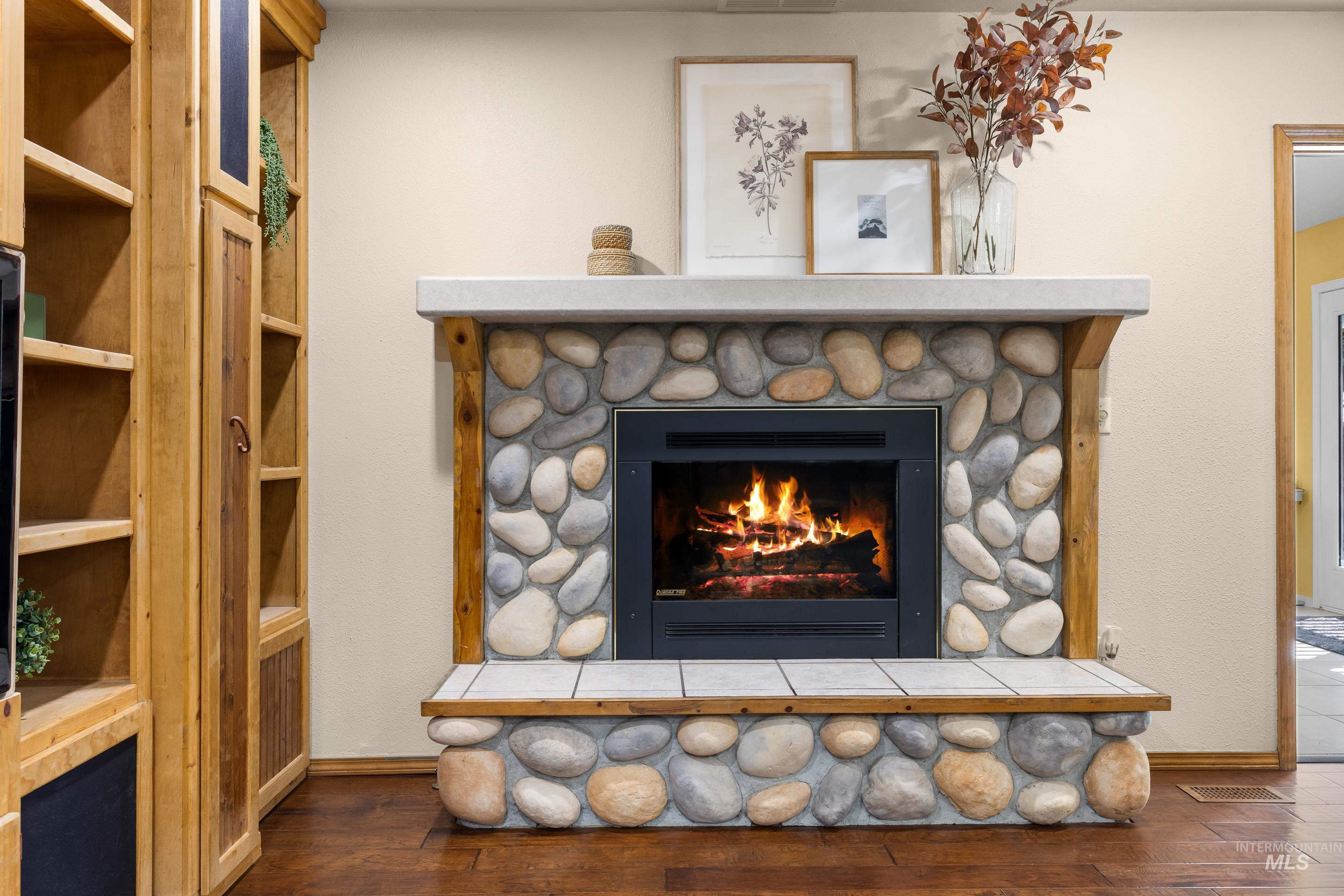 Detailed view of wood finished floors and a fireplace