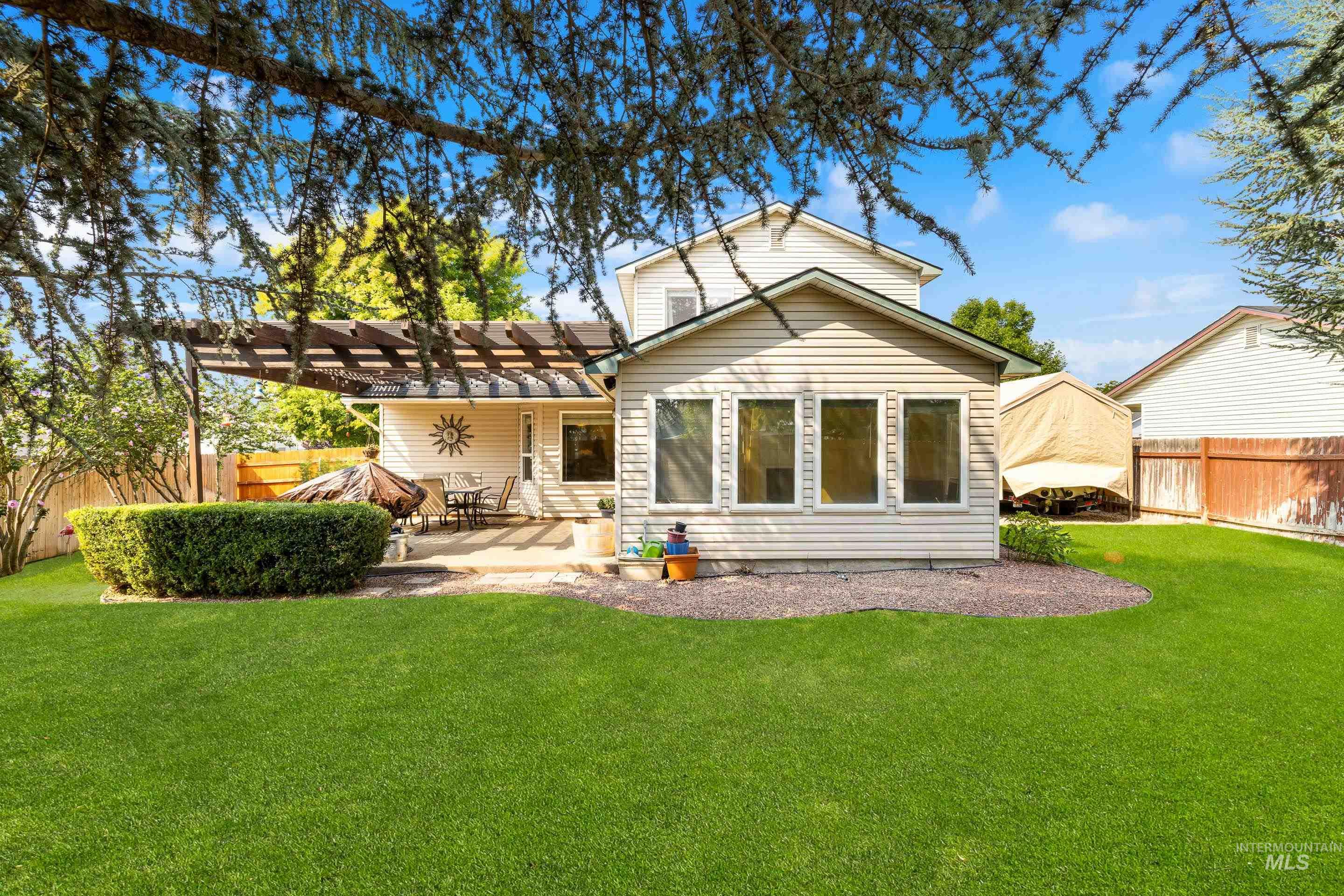 Back of house featuring a fenced backyard, a pergola, and a patio area