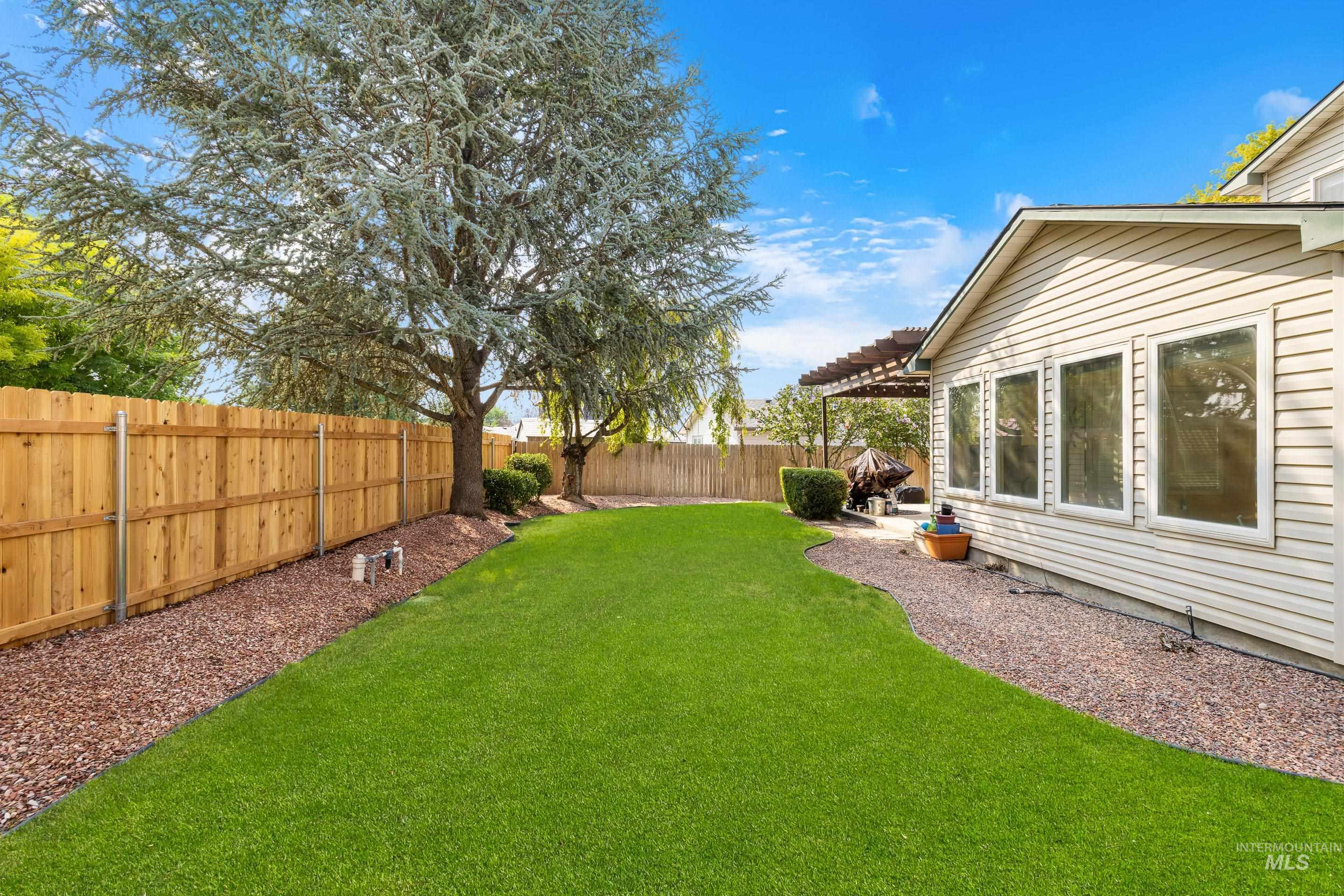 Fenced backyard with a patio