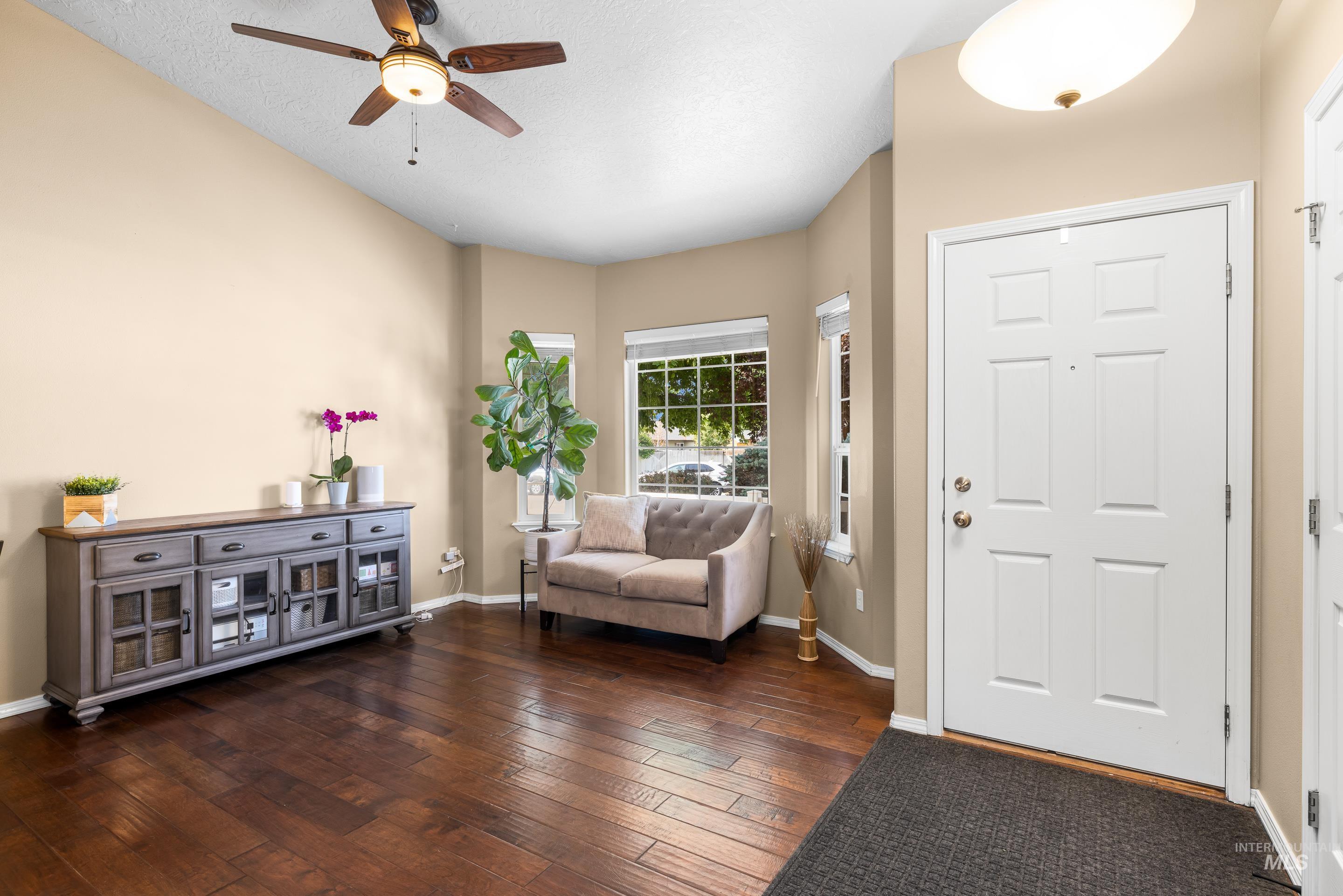 Entryway featuring dark wood-style floors and ceiling fan