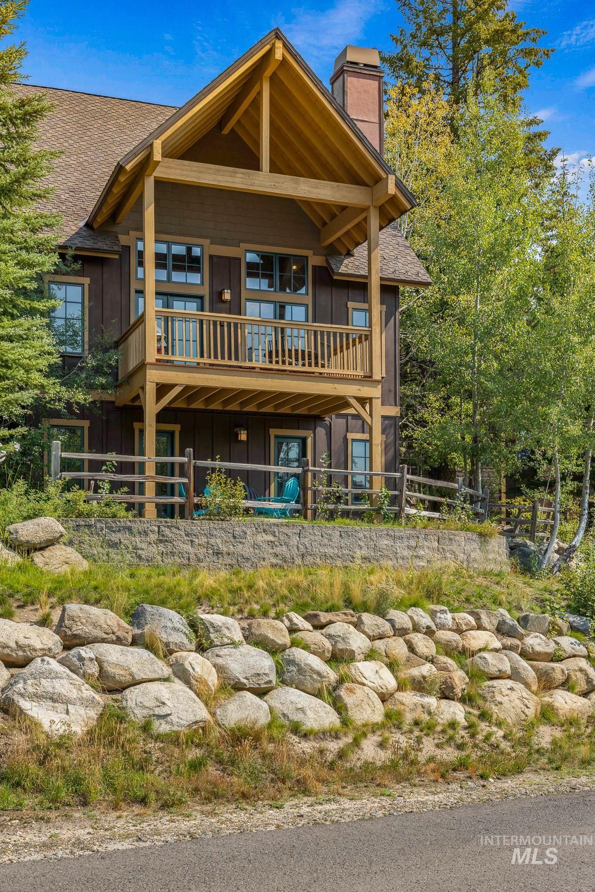 Rear view of property featuring a large deck to enjoy the views.