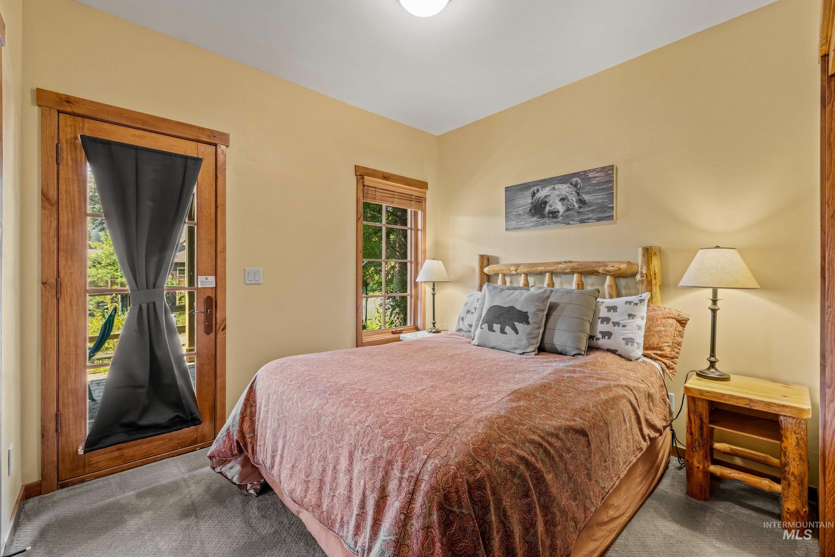 Bedroom with carpet flooring and access to outside