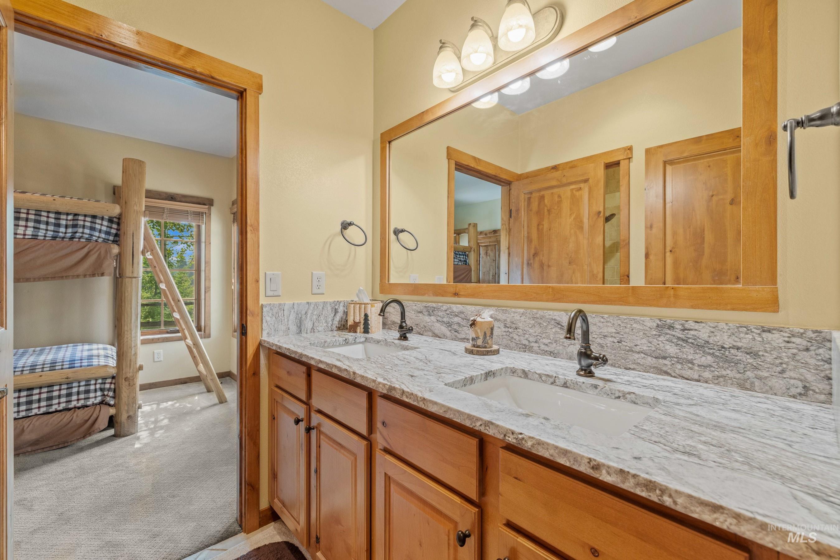 Jack and Jill bathroom with double vanity and seperate shower and toilet area