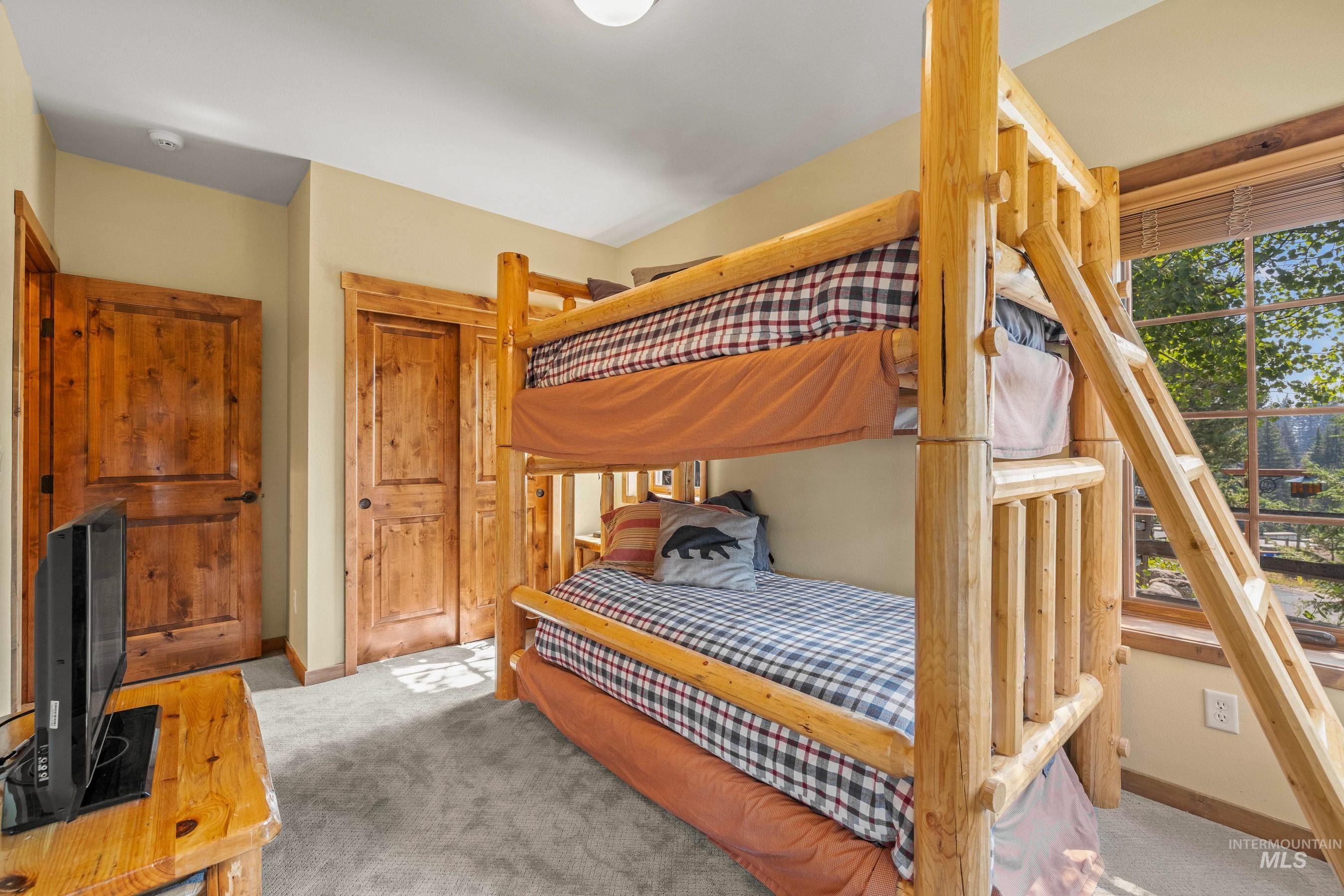Bedroom featuring carpet and a closet