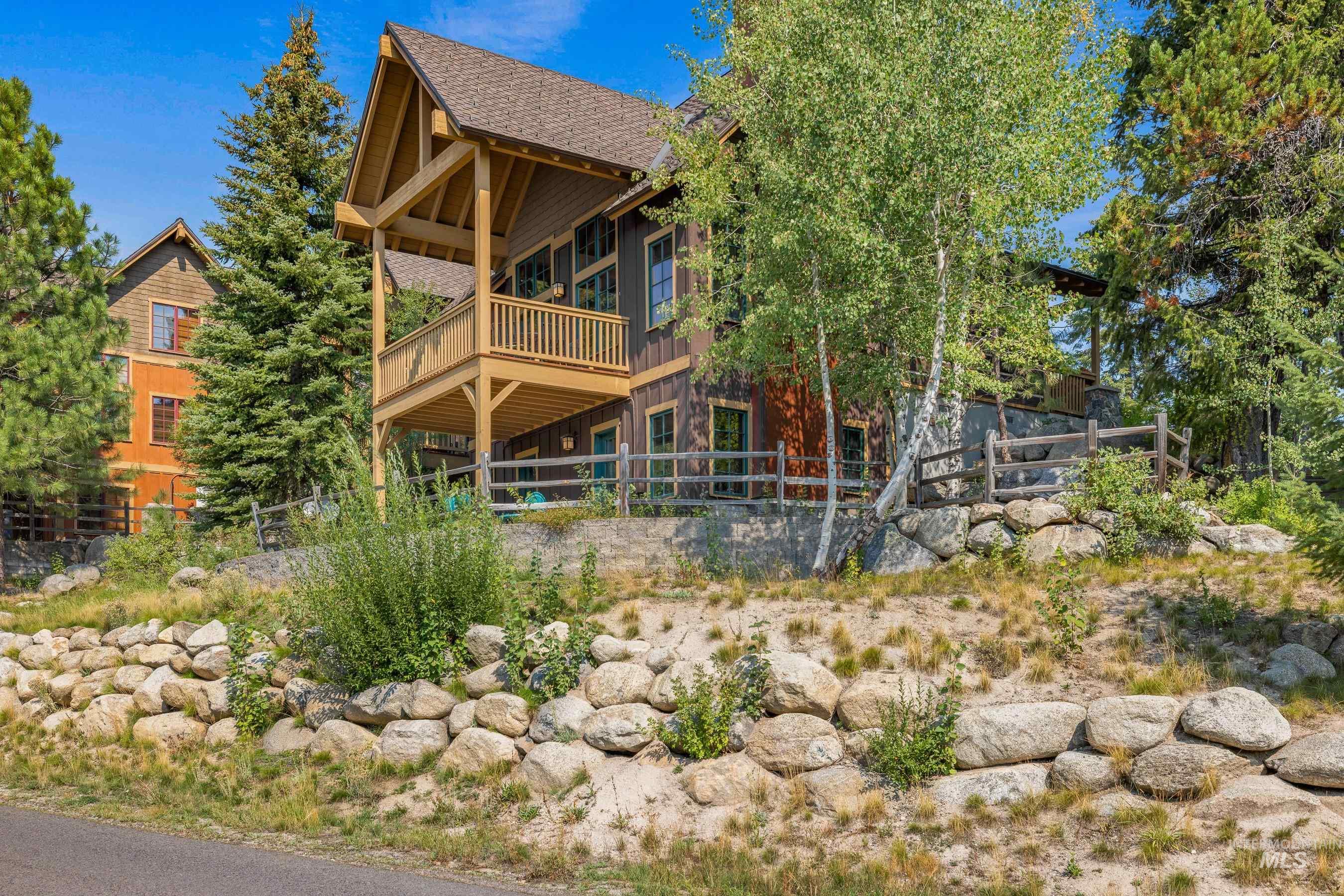 Rear view of house with a wooden deck, and a covered patio