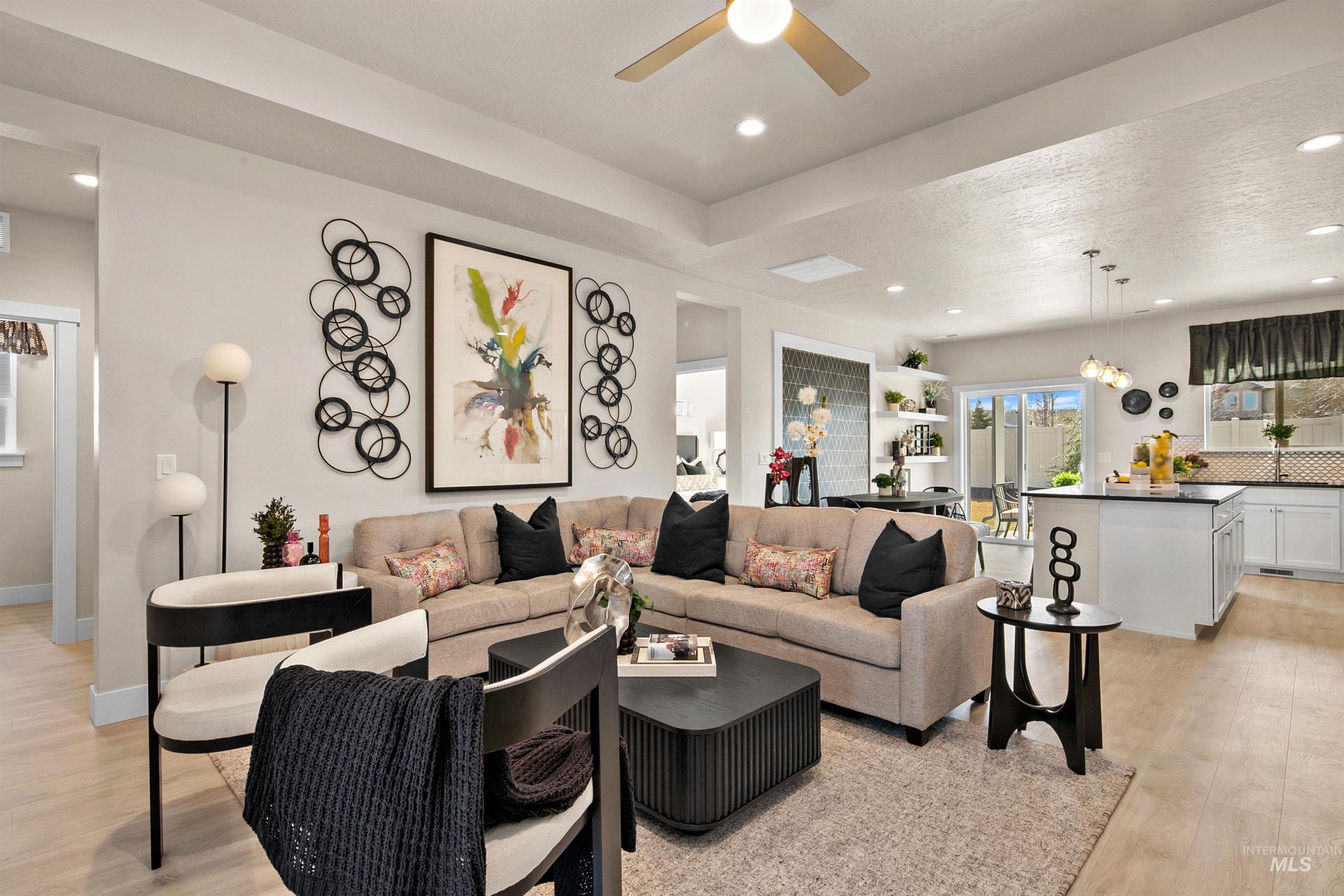 Living room featuring light wood finished floors, recessed lighting, and a ceiling fan
