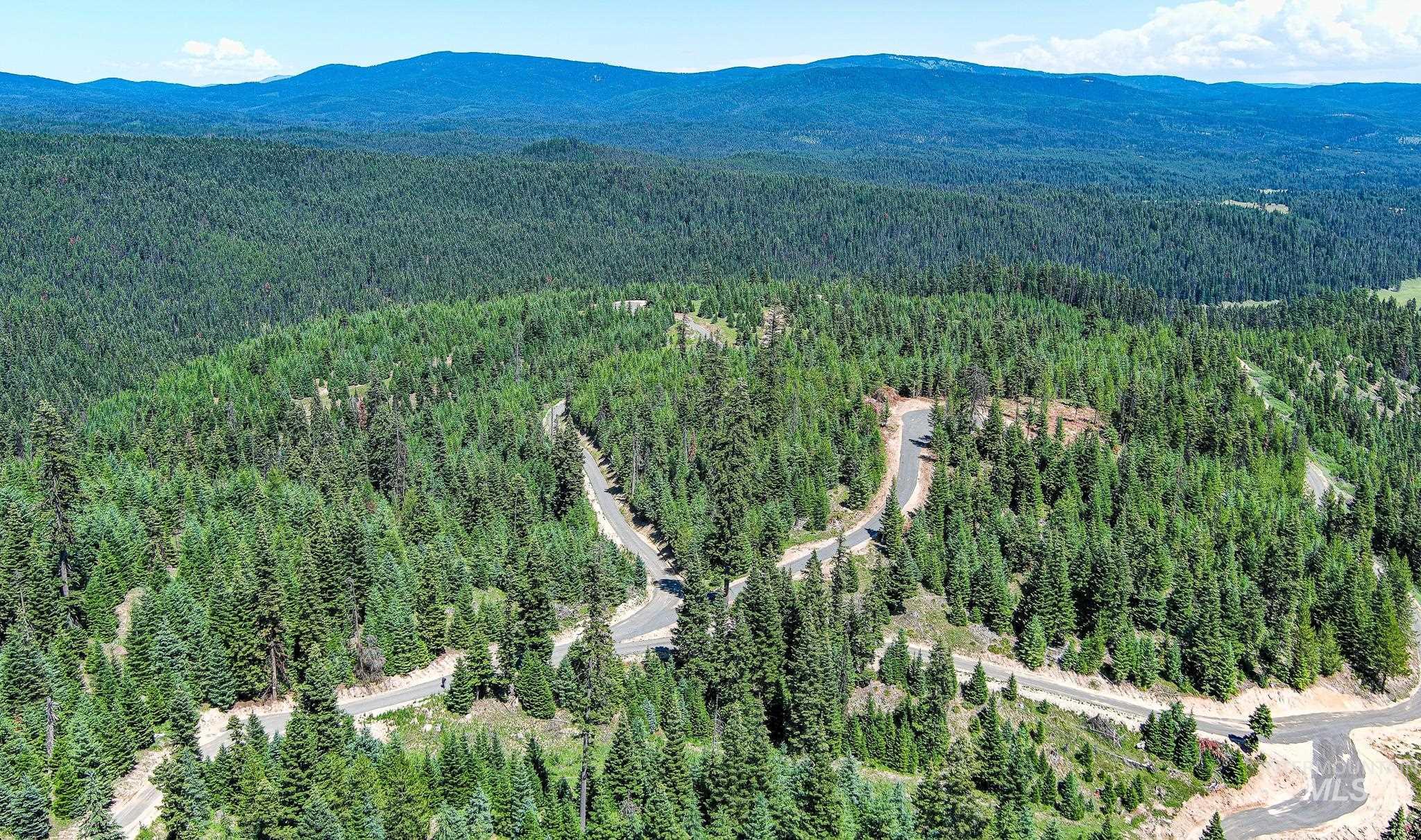 Aerial view of property's location with a mountain backdrop
