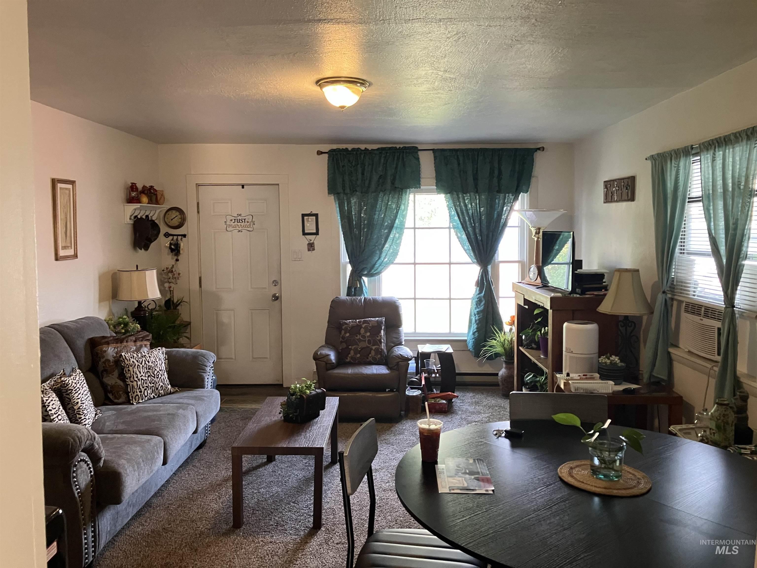Living area with a textured ceiling and cooling unit