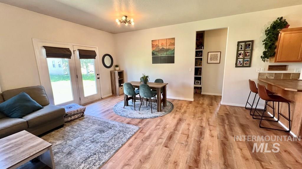 Dining area with light wood-style flooring and baseboards