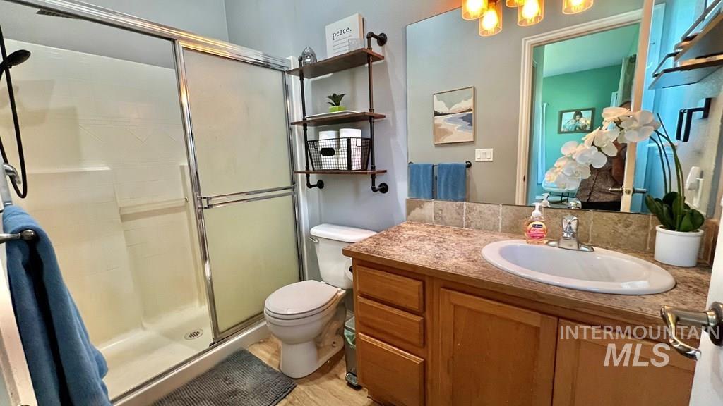 Full bath with a stall shower and vanity