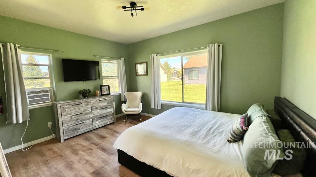 Bedroom with baseboards and wood finished floors