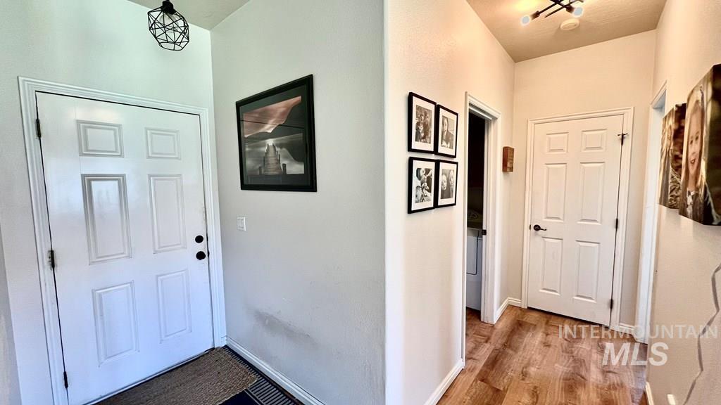 Foyer entrance with wood finished floors and baseboards