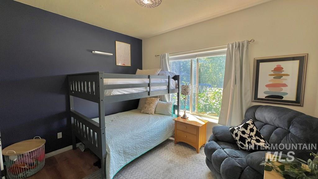 Bedroom featuring wood finished floors and baseboards