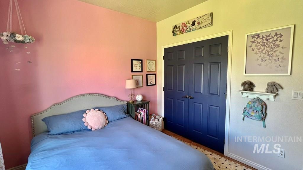 Bedroom with a closet and baseboards