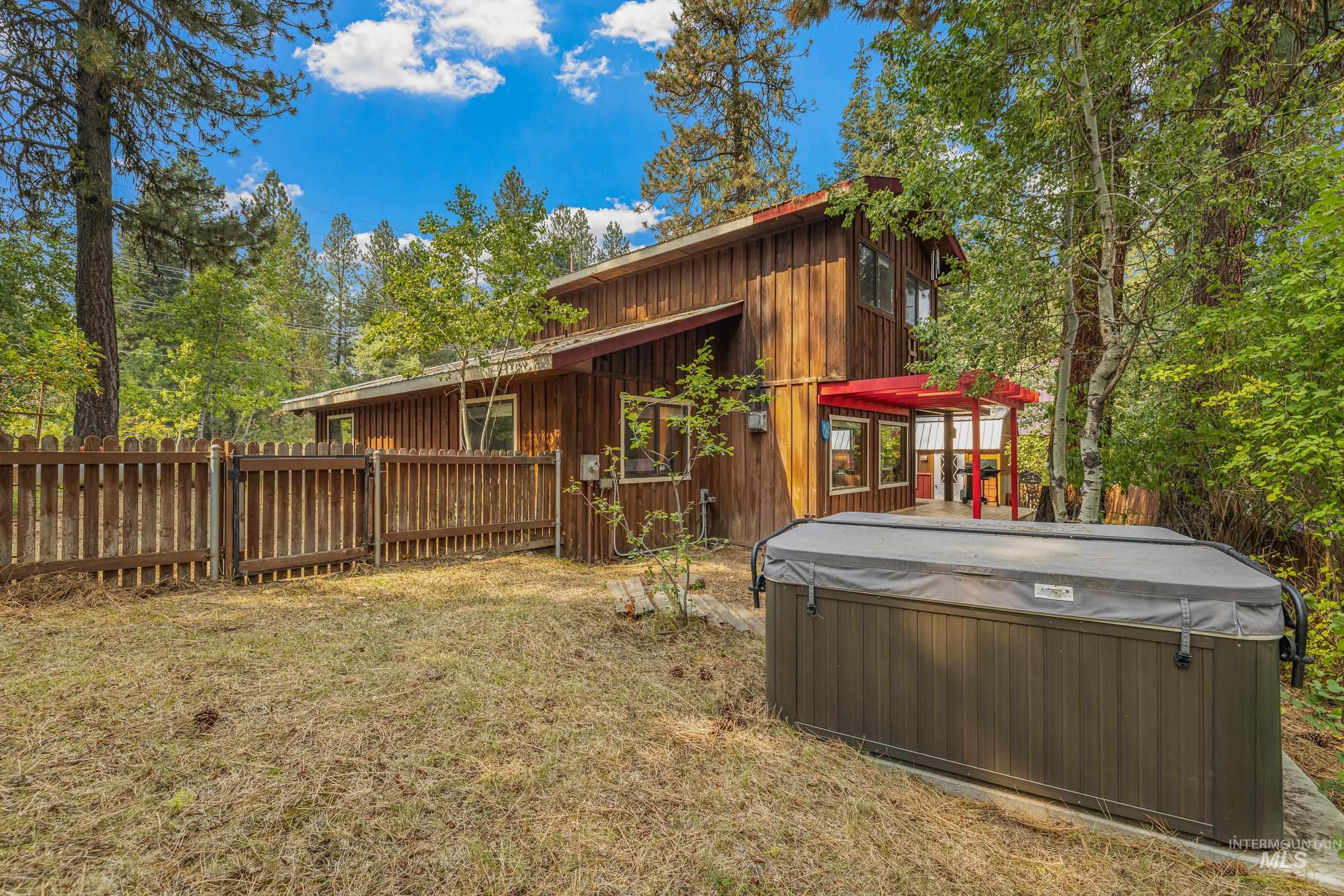 View of home's exterior with a hot tub