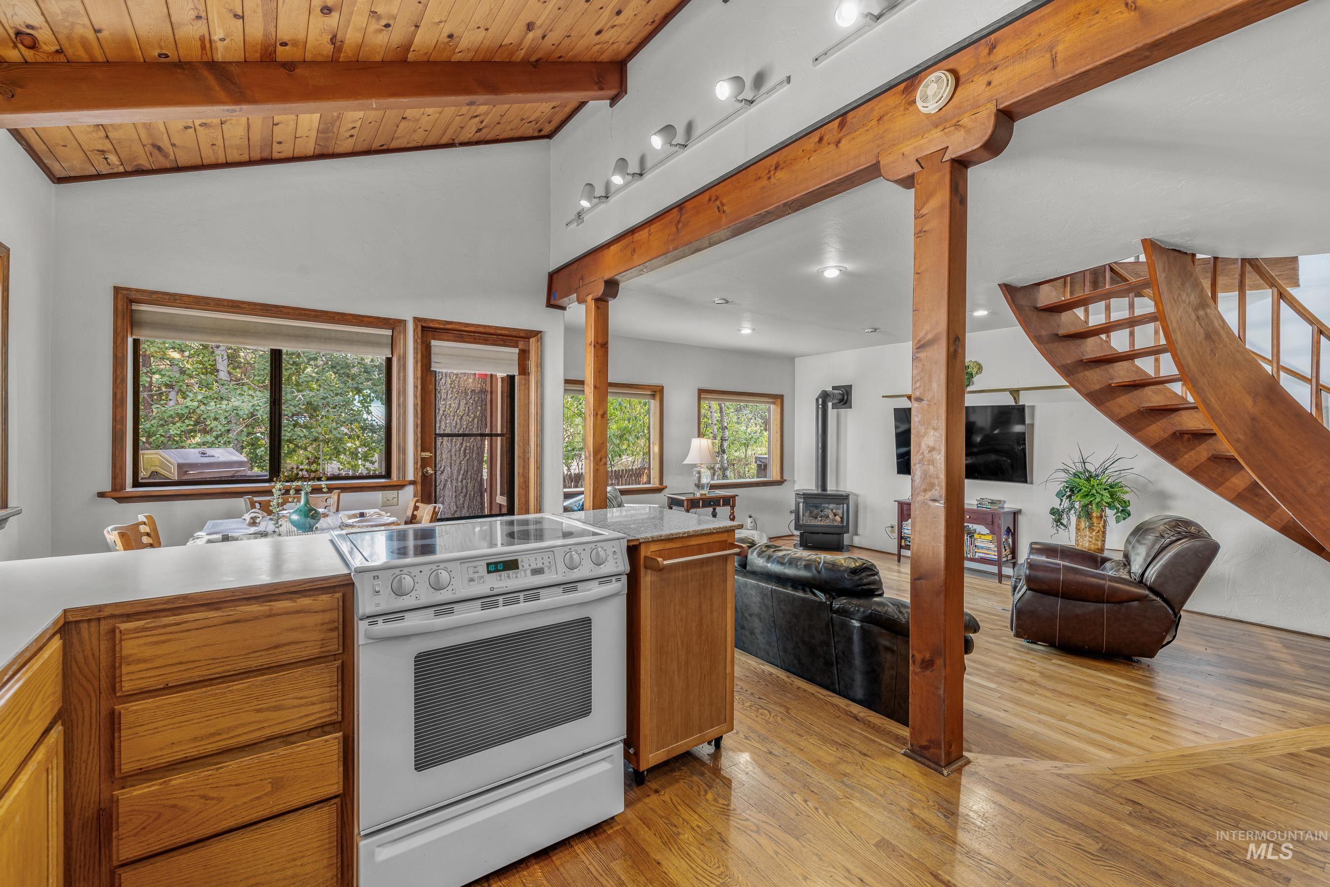 Kitchen with white electric range oven, healthy amount of natural light, light countertops, and light wood finished floors