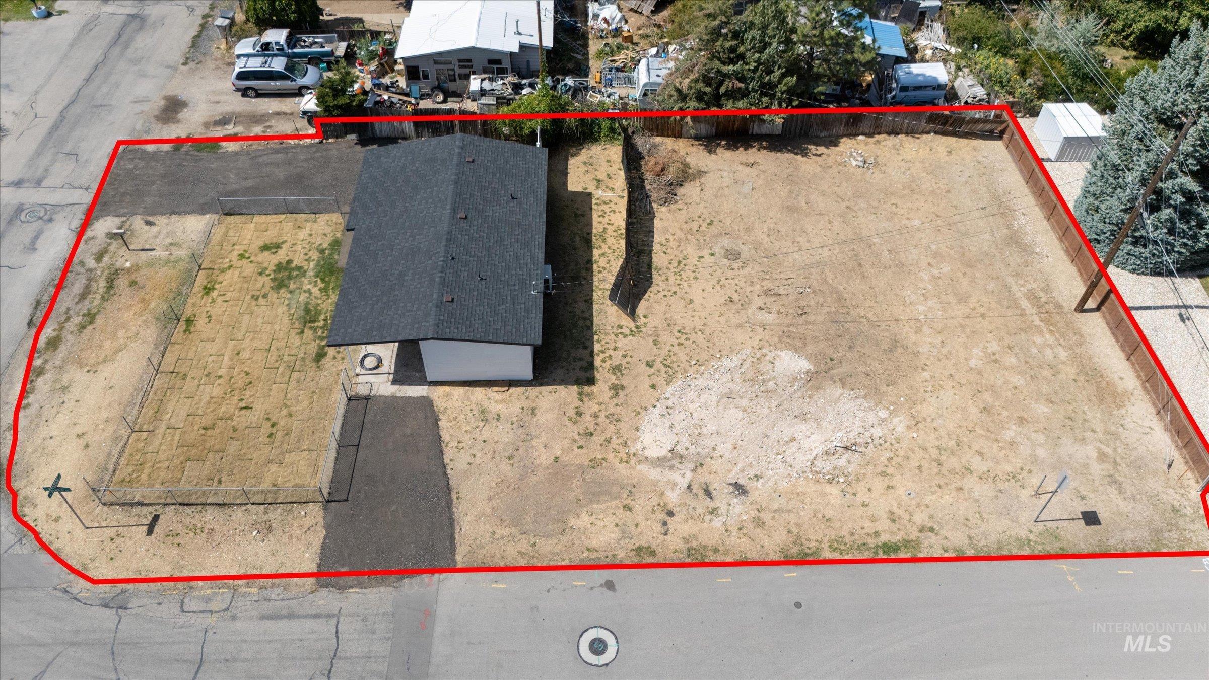 Aerial view of property and surrounding area with property parcel outlined