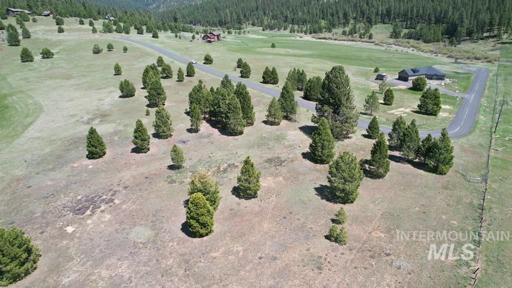 Aerial view of property's location with a heavily wooded area