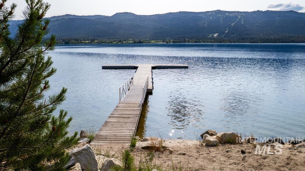 Dock area with a water and mountain view