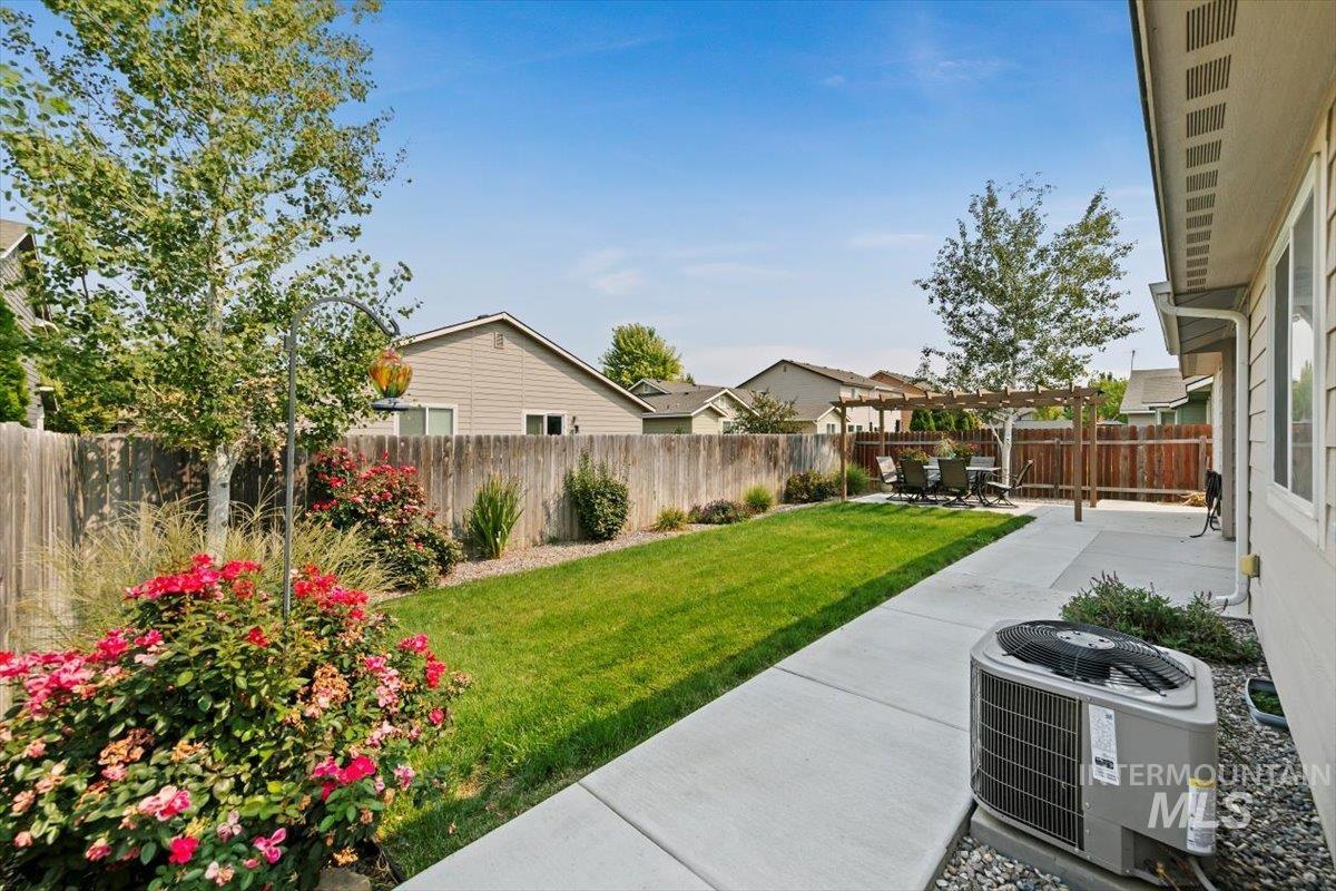 Fenced backyard featuring a patio and a pergola