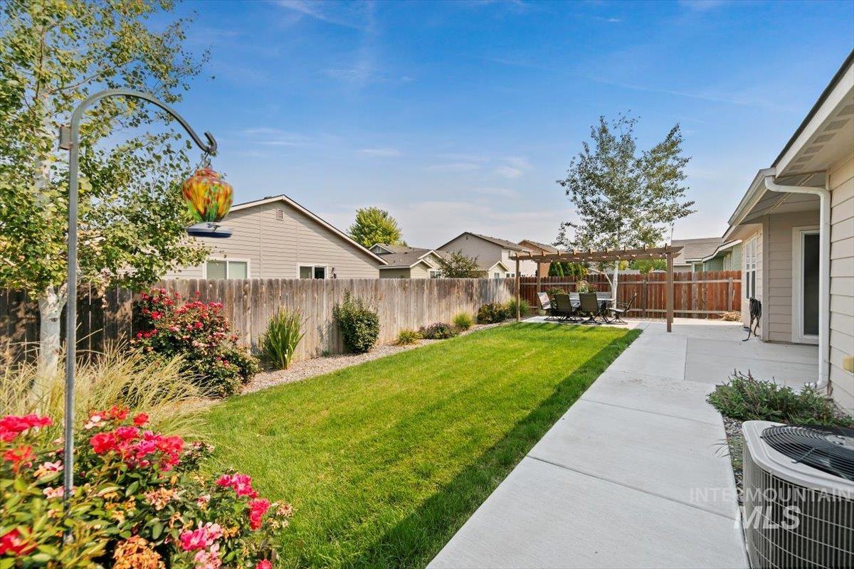Fenced backyard with a pergola and a patio area