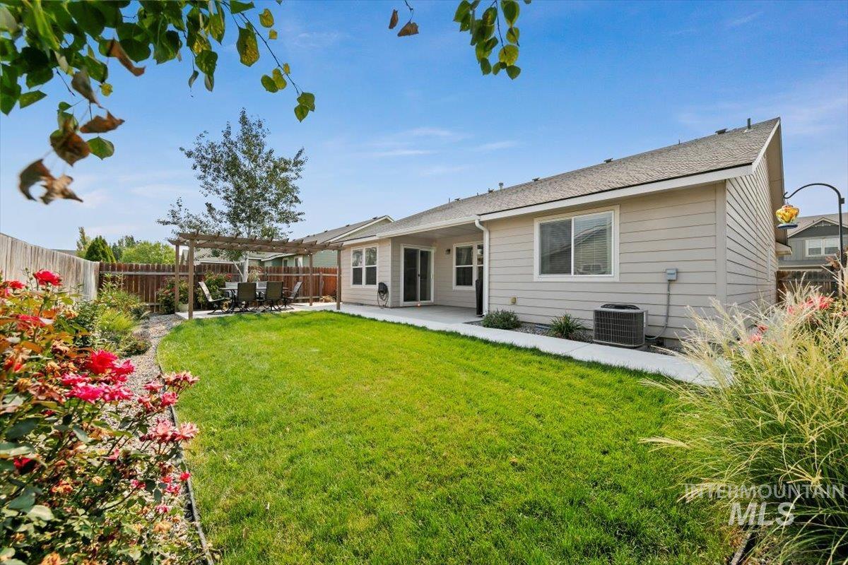 Back of property featuring a patio area, a pergola, and a fenced backyard