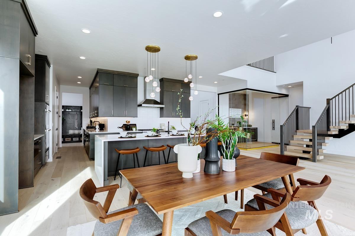Dining room featuring light wood-style flooring, stairs, and recessed lighting