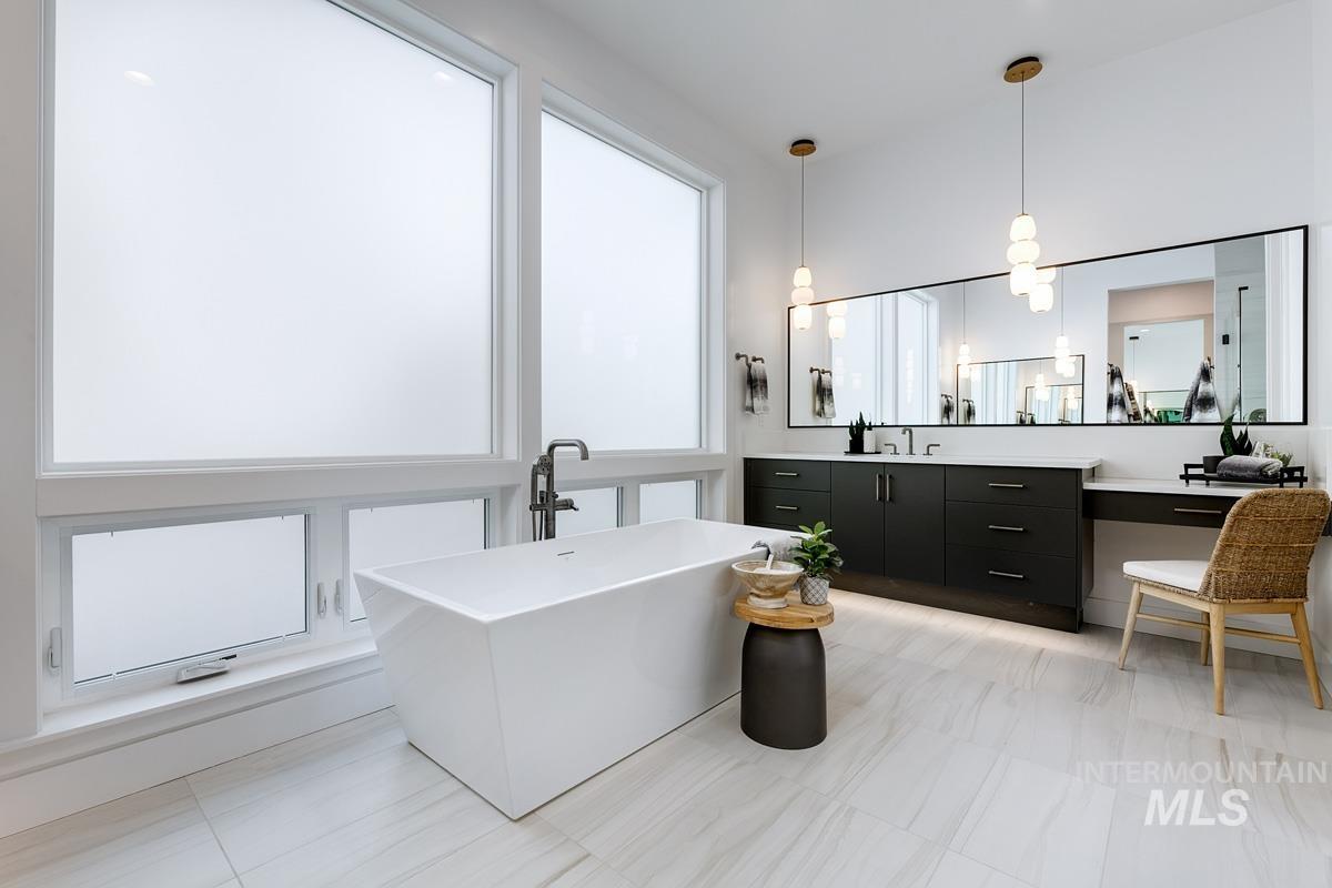Full bathroom featuring vanity and a freestanding tub