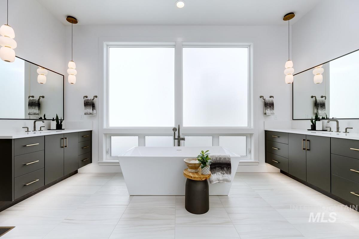 Full bath with a freestanding bath and two vanities