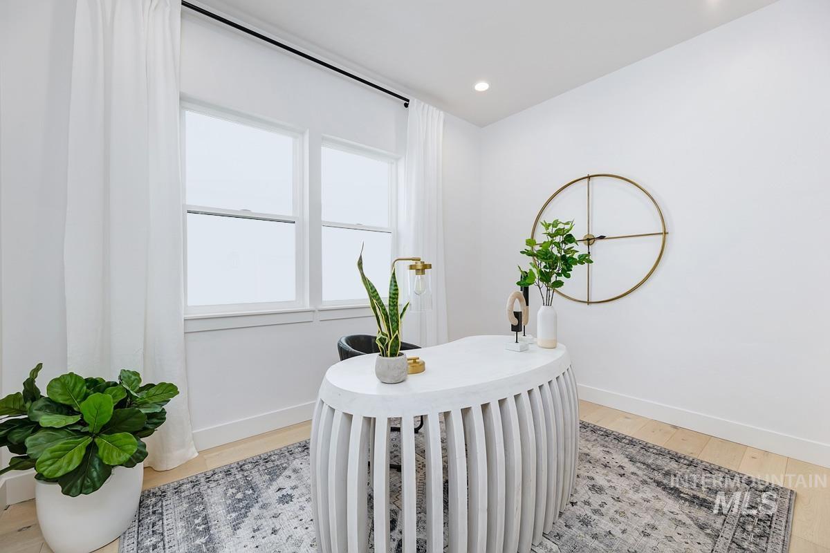 Office space featuring light wood-style floors and recessed lighting