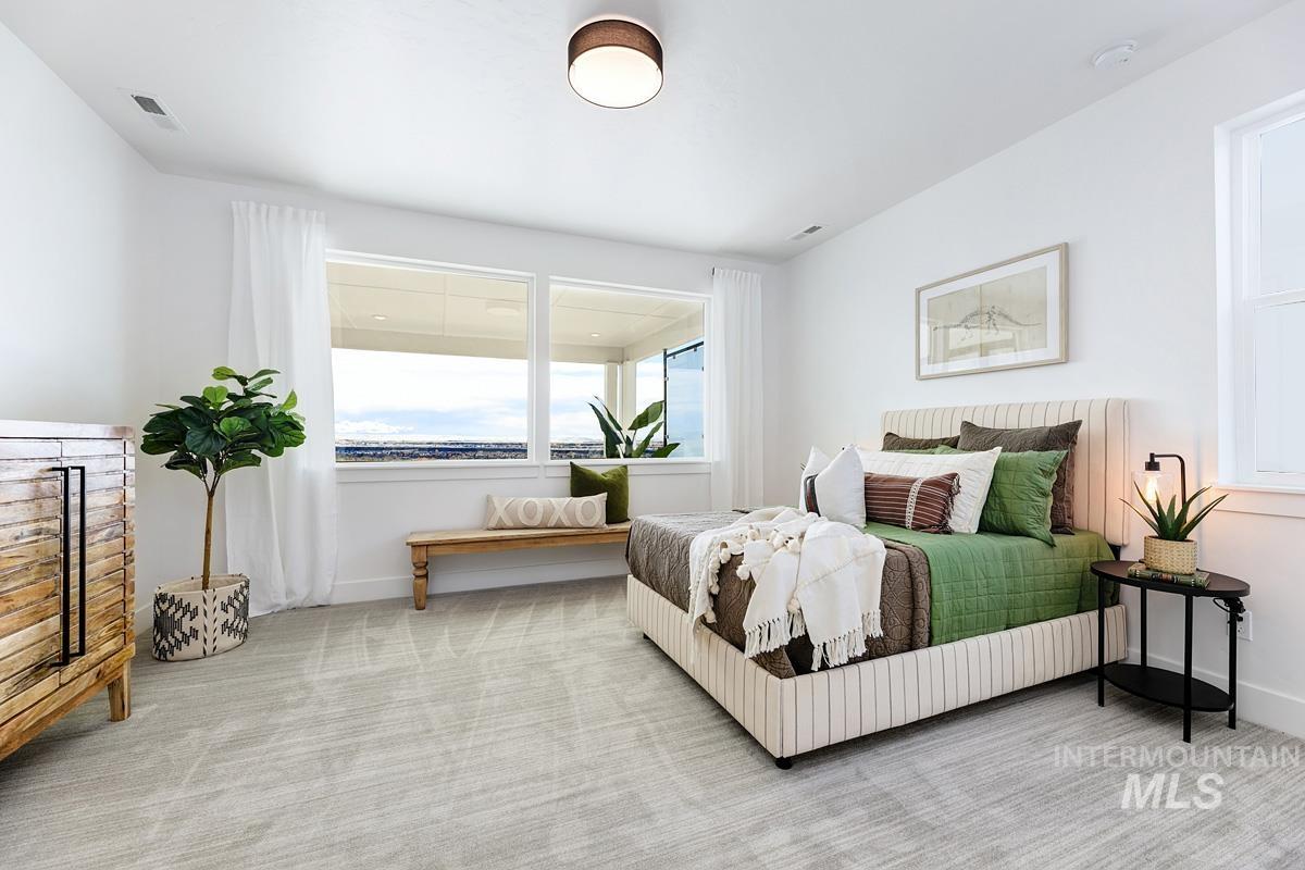 Carpeted bedroom featuring baseboards