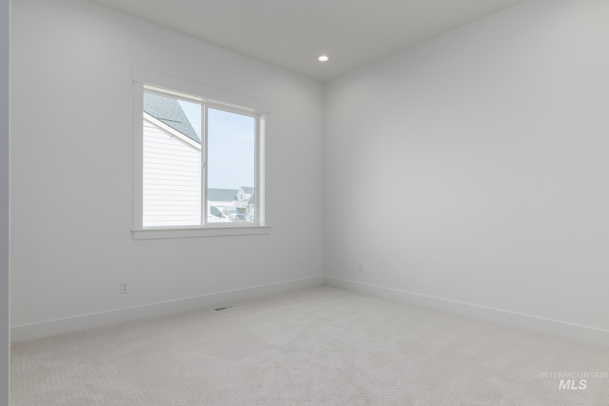 Spare room with carpet and recessed lighting