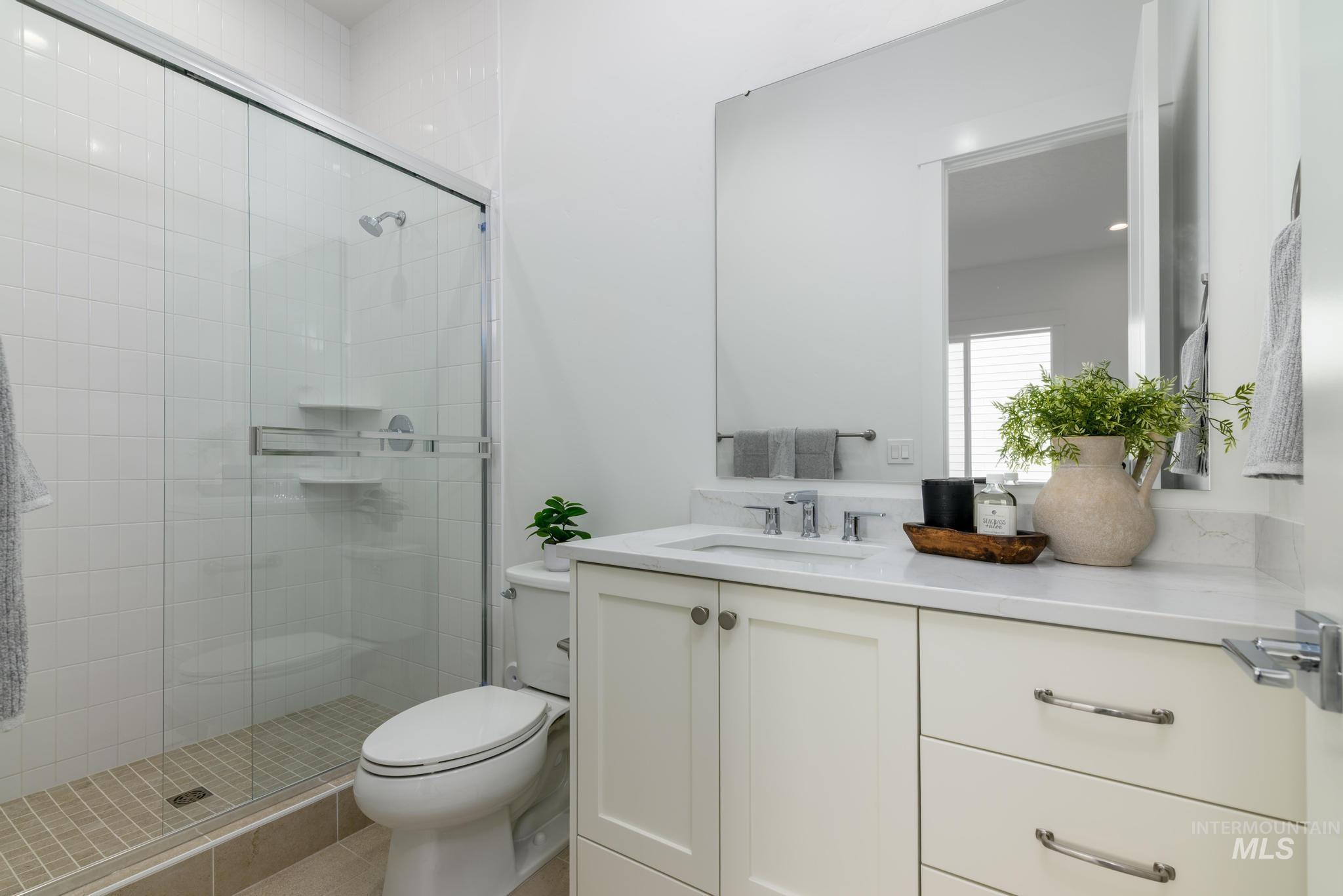 Full bathroom featuring vanity and a shower stall