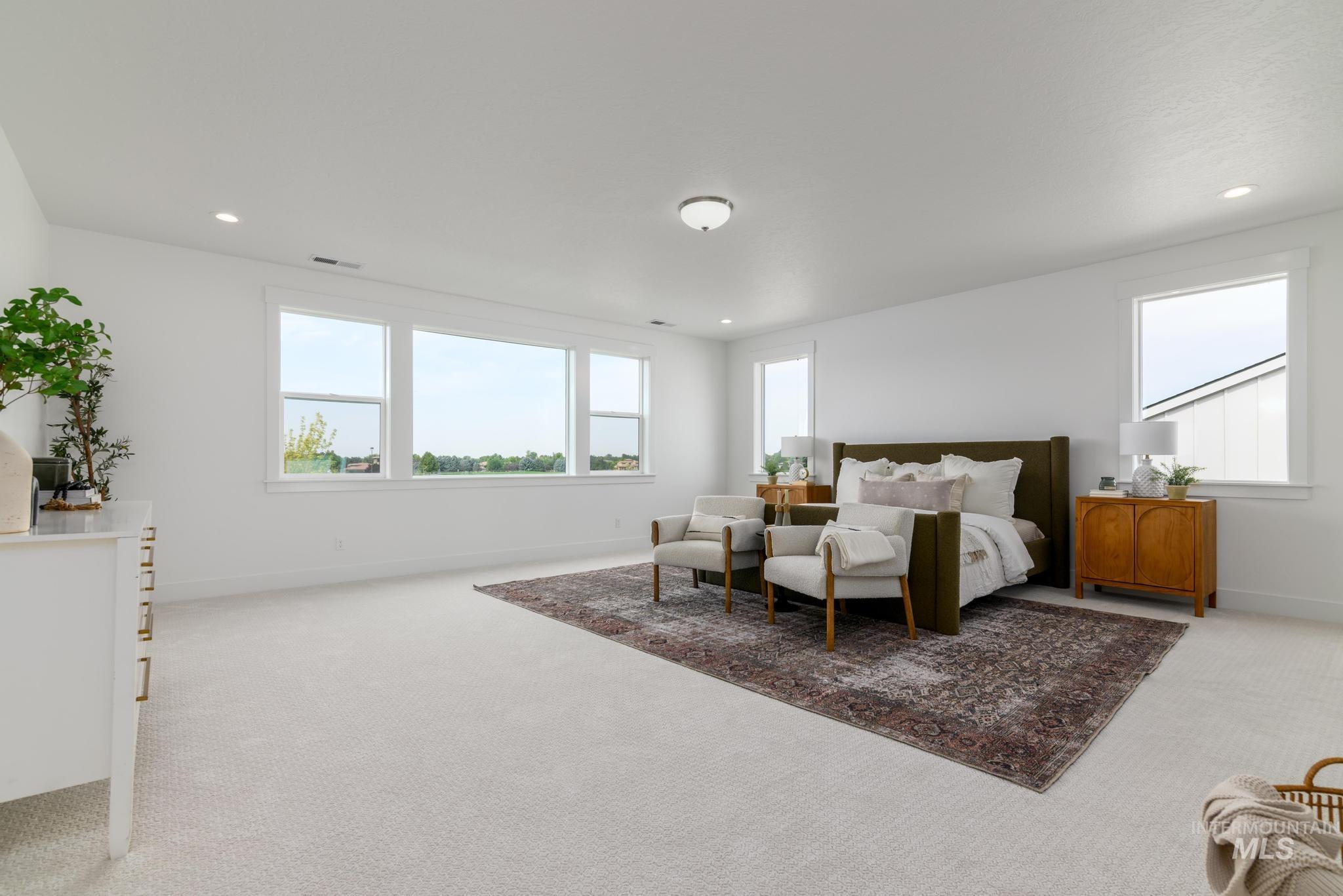 Bedroom featuring light carpet and recessed lighting