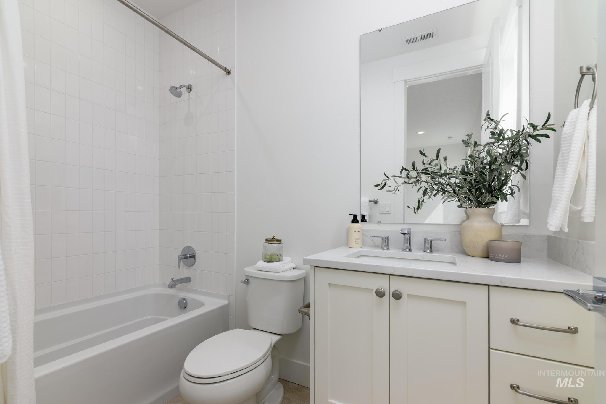 Bathroom with shower / bath combo and vanity