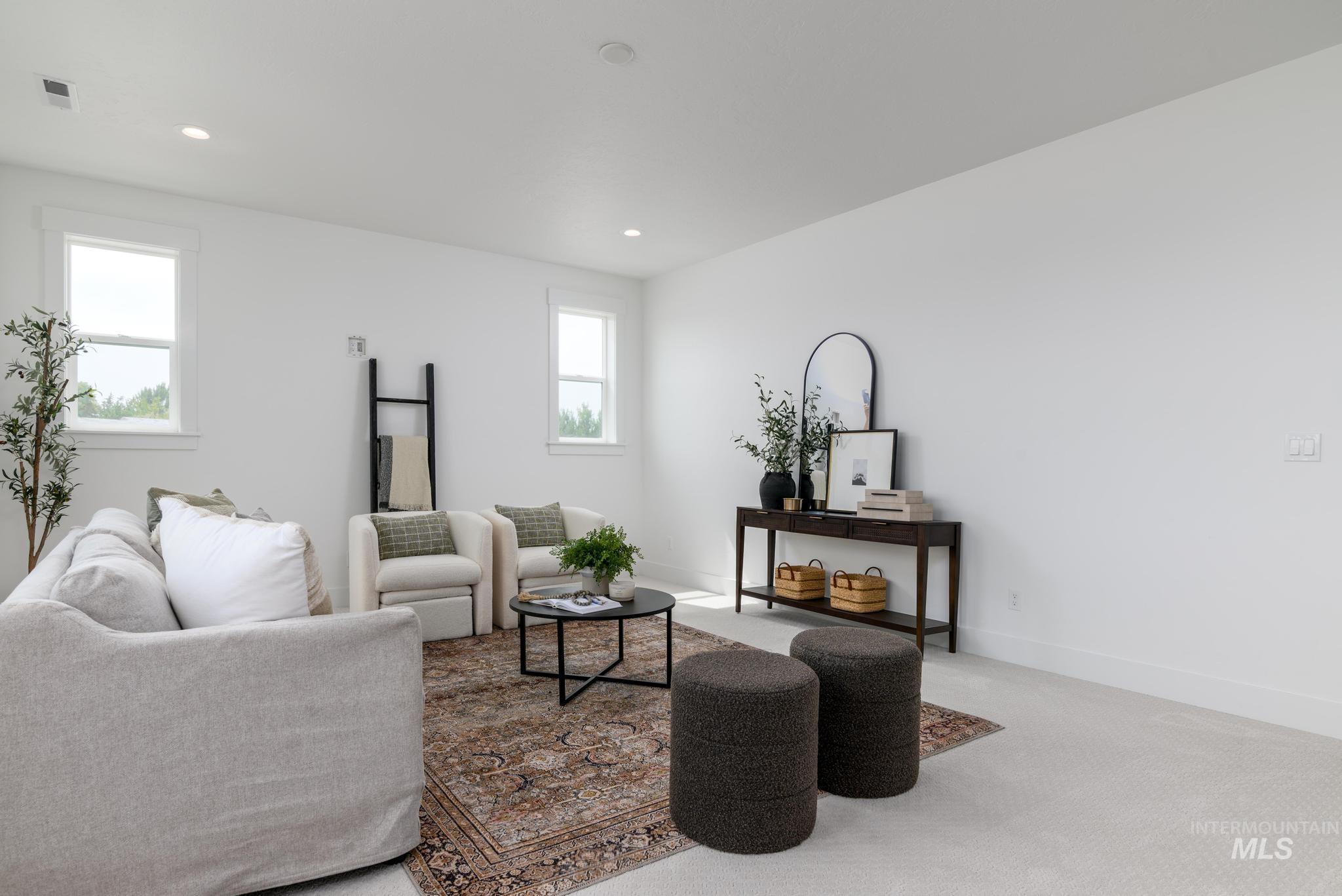 Carpeted living area featuring recessed lighting