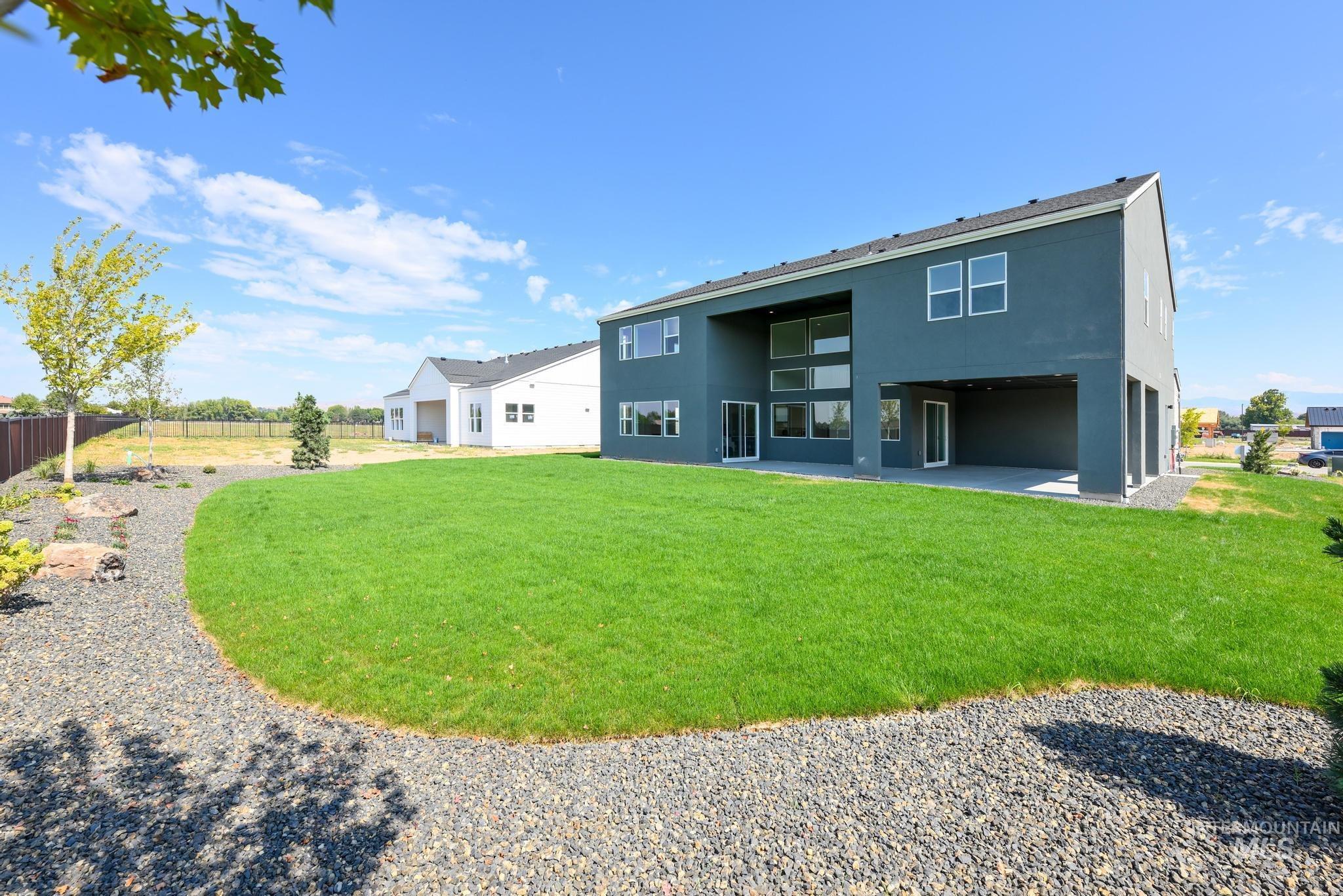 Rear view of property with stucco siding and a patio