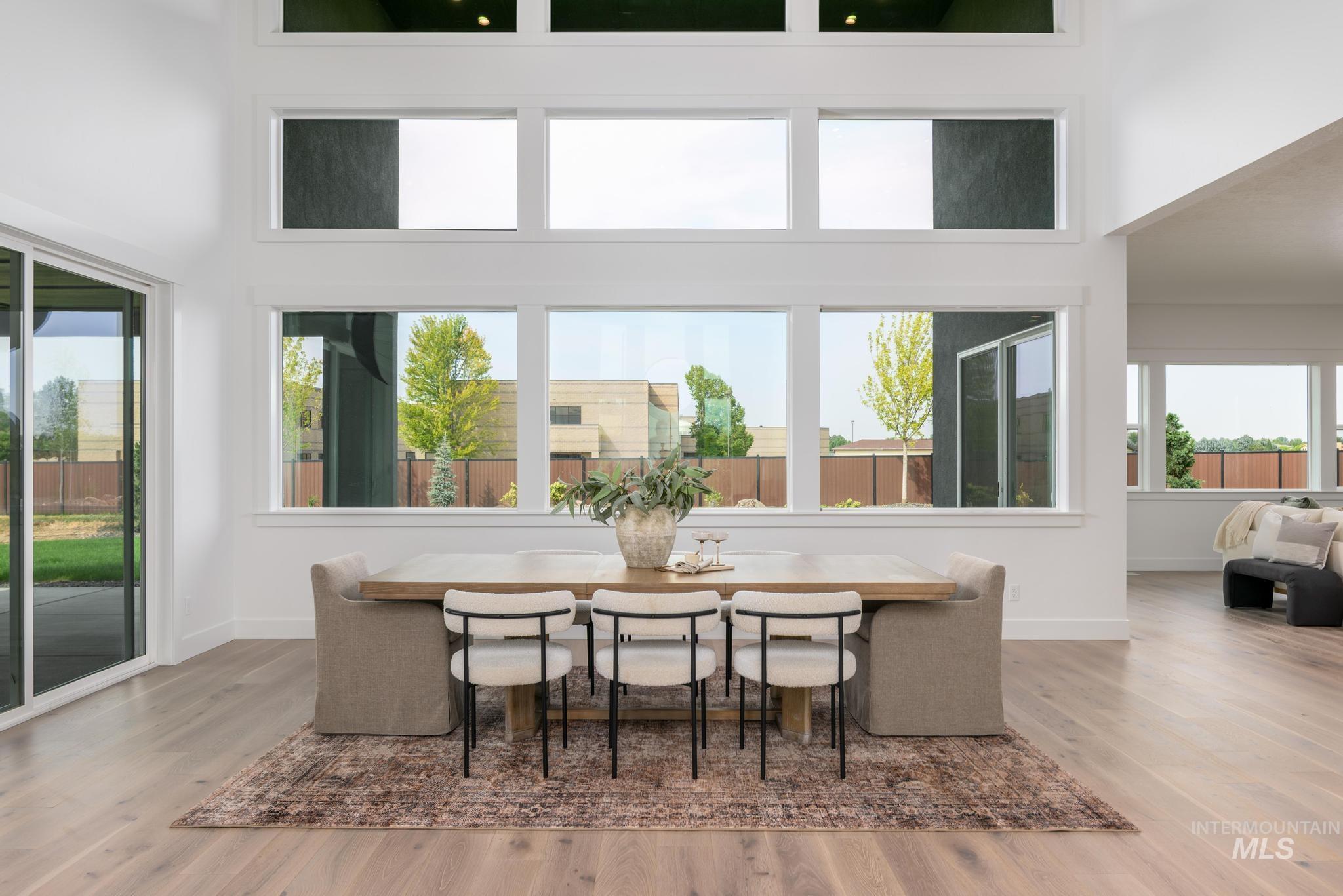 Dining space featuring wood finished floors and a high ceiling