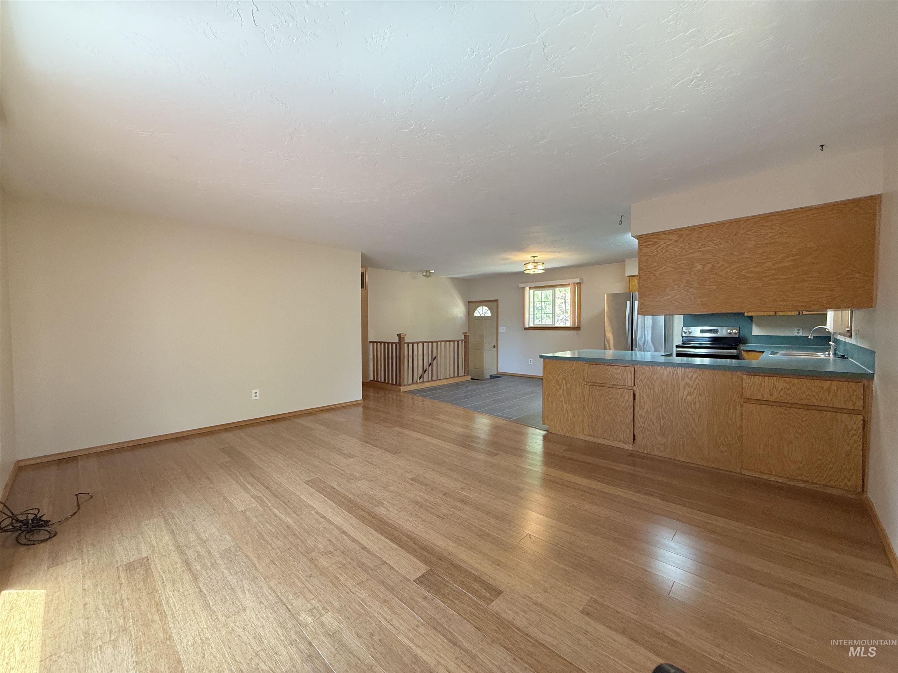 Unfurnished living room featuring wood finished floors
