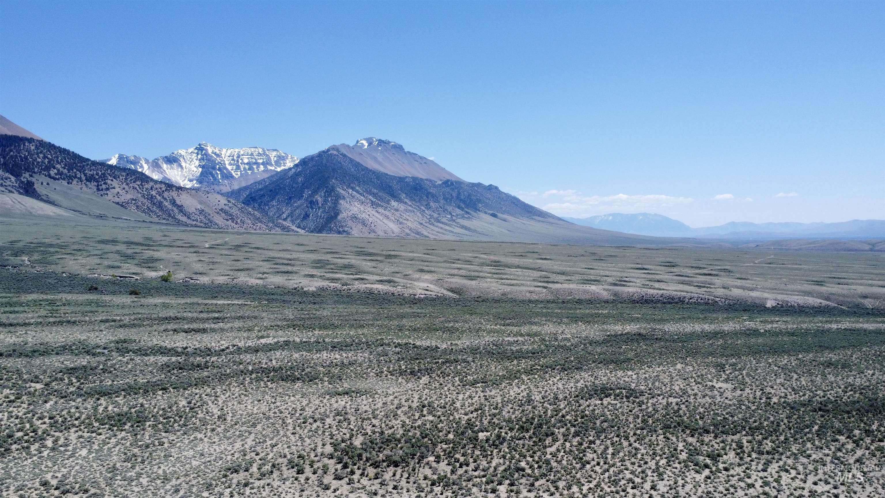 View of mountain backdrop with rural landscape