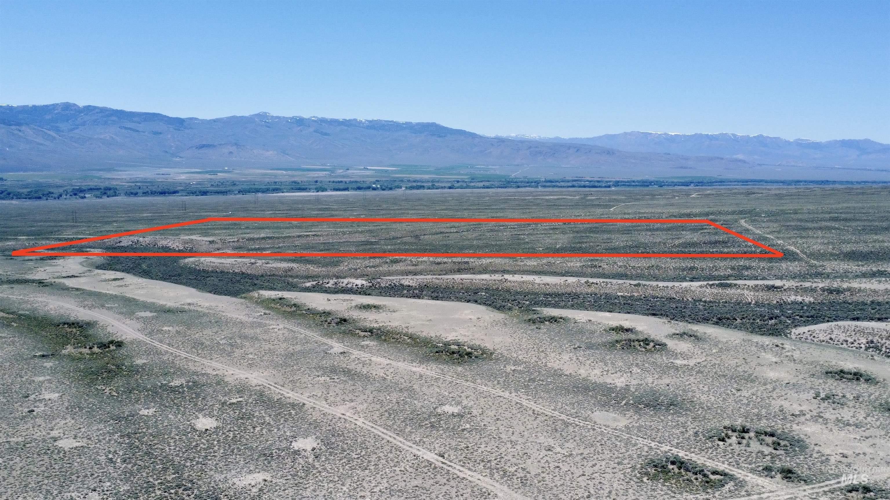 Aerial view of sparsely populated area featuring a mountain backdrop