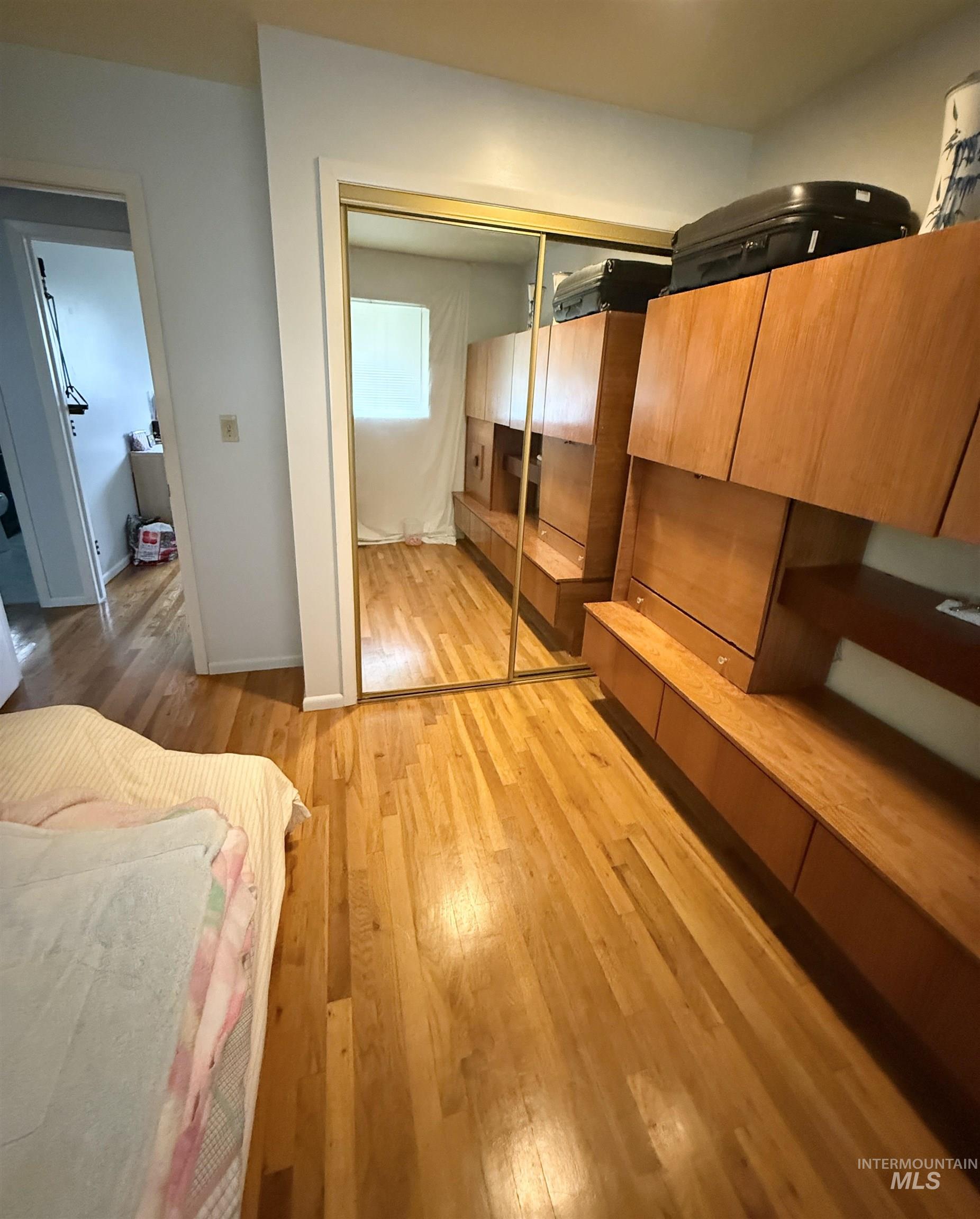 Bedroom featuring light wood-type flooring and a closet