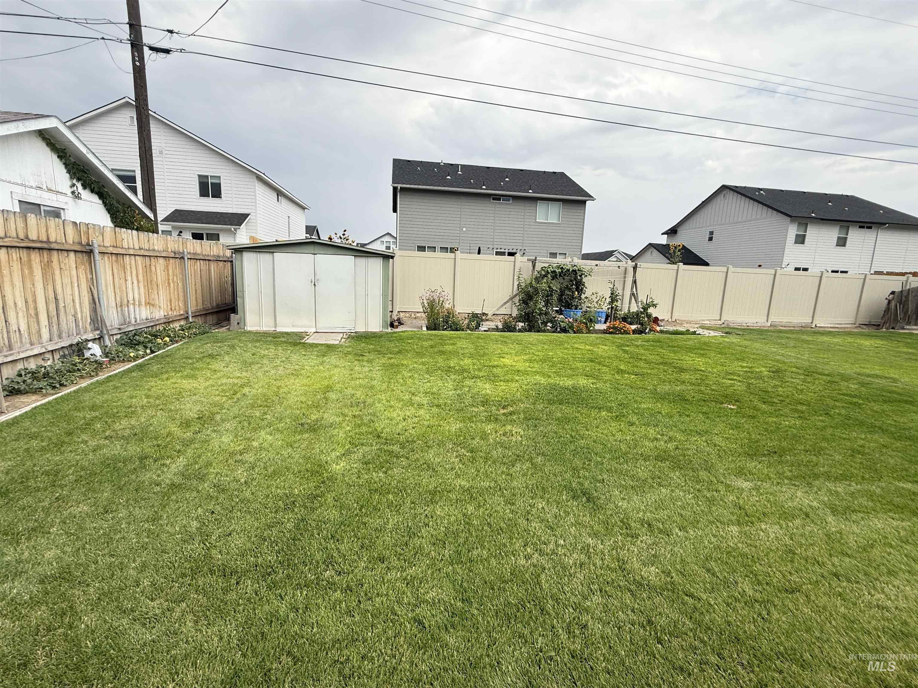 Fenced backyard with a shed