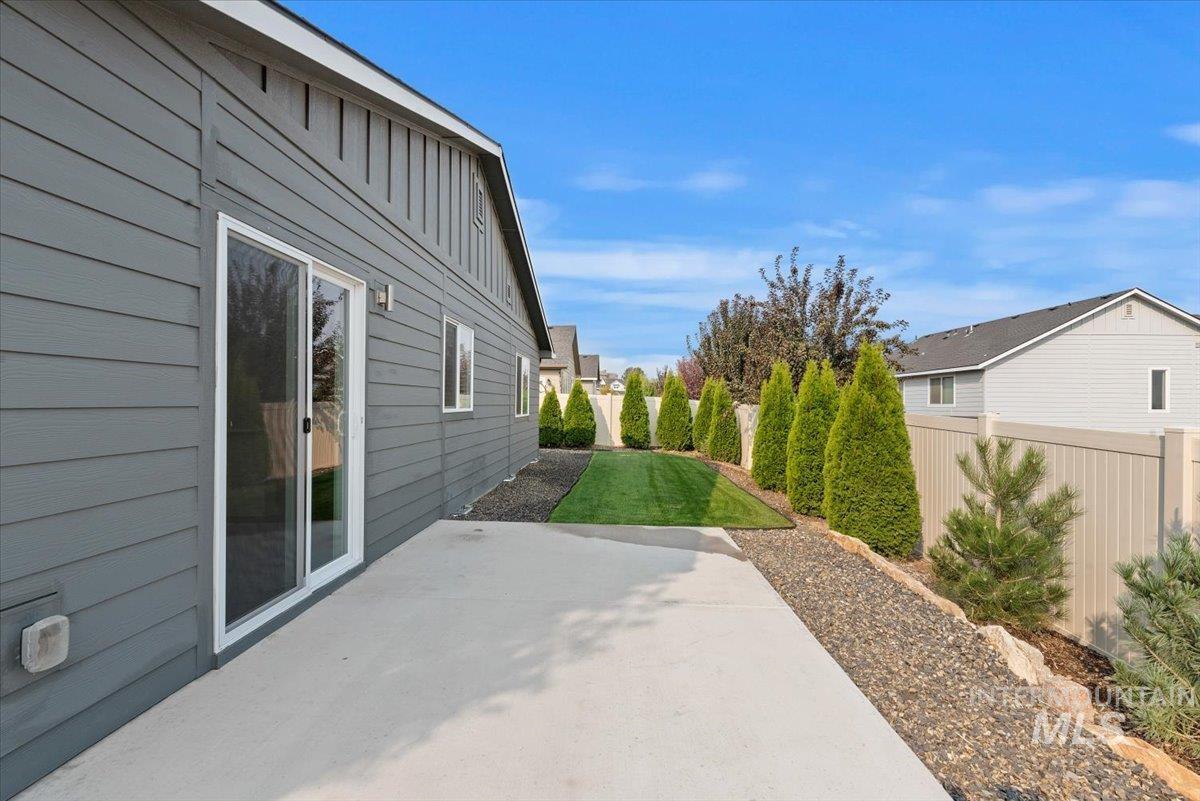 Fenced backyard with a patio