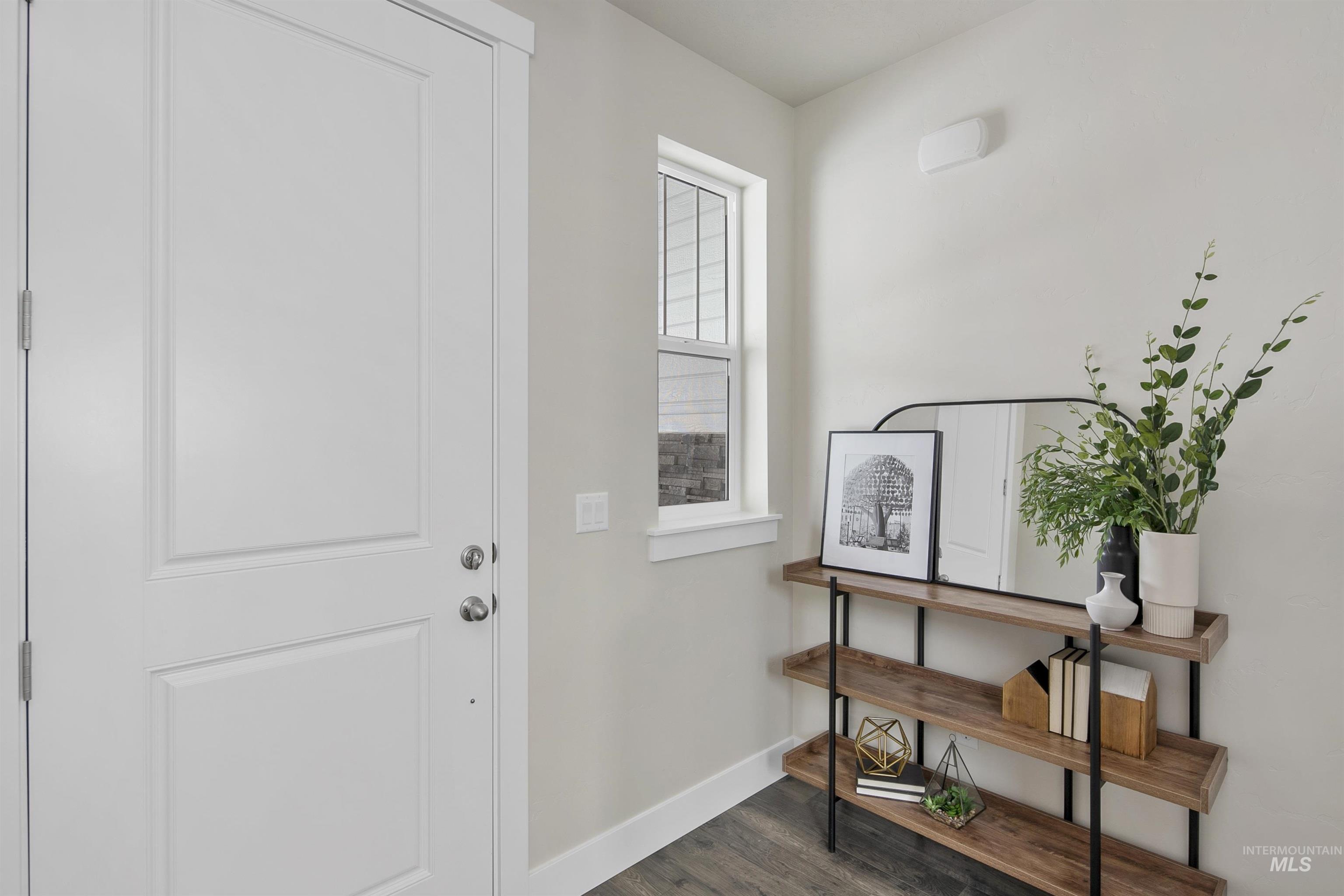 Foyer with baseboards and dark wood-style floors
